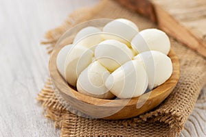 Mozzarella cheese in wooden bowl