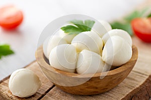 Mozzarella cheese in wooden bowl