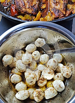 Mozzarella Ñheese balls in olive oil with Provencal herbs in the bowl