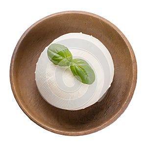 Mozzarella in a plate with basil leaves, top view, isolated on white background.