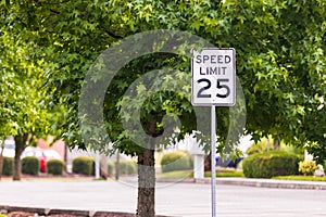 Mph sign with a tree and concrete road