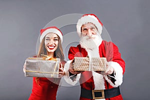 Mr. and Mrs. Claus Hold Out Gifts