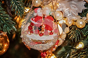 Mr and Mrs Santa kissing retro really old Christmas decoration of colloid and styrofoam and beads and trim hanging from a tree -