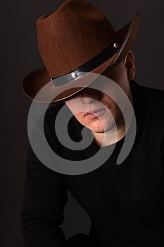 Mr. X. The secretive man in a cowboy hat covering his eyes