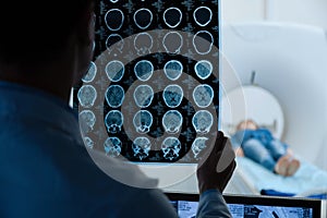 MRI scan images being examined by a doctor