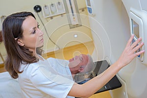 MRI technologist operating machine