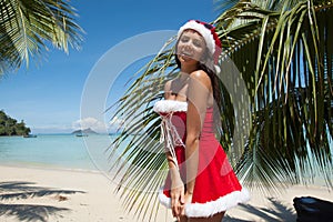 Mrs. Claus on tropical beach