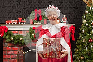 Mrs. Clause holding a Christmas present