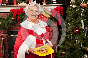 Mrs. Clause holding a plate of cookies