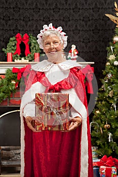 Mrs. Clause holding a Christmas present