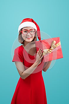 Mrs. Santa. Beautiful young asian woman in santa`s hat holding a