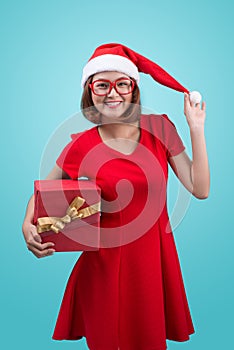 Mrs. Santa. Beautiful young asian woman in santa`s hat holding a