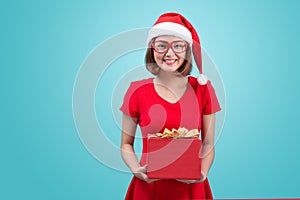 Mrs. Santa. Beautiful young asian woman in santa`s hat holding a