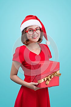Mrs. Santa. Beautiful young asian woman in santa`s hat holding a
