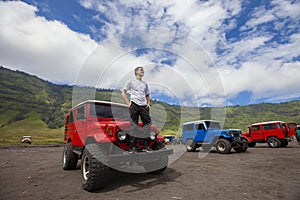 Mt.Bromo, Pasuruan, East Java, Indonesia - Man with 4wd car on Adventure driving Off-road Jeep 4WD into Beautiful active Volcano