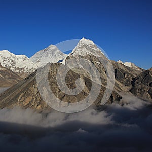 Mt Everest and other high mountains surrounded by a sea of fog