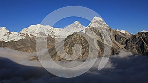 Mt Everest and other high mountains surrounded by a sea of fog