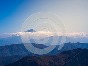 Mt. Fuji through the dense shiny cloud with the blue sky