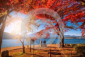 Mt. Fuji over Lake Kawaguchiko with autumn foliage and couple love at sunrise in Fujikawaguchiko, Japan