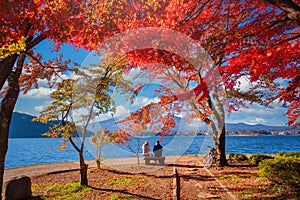 Mt. Fuji over Lake Kawaguchiko with autumn foliage and couple love at sunrise in Fujikawaguchiko, Japan