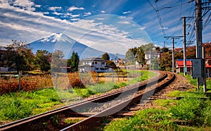 Mt. Fuji with train and rice field at daytime in Fujiyoshida, Japan