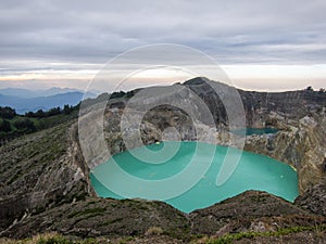 Mt Kelimutu`s bright blue volcanic lake, mysterious and popular. Moni, flores, Indonesia photo