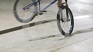 MTB bicycle rider does various tricks while riding in skatepark . Extreme Sports, rider does tailwhip at nigh