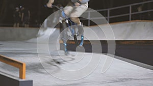 MTB bicycle rider does various tricks while riding in skatepark . Extreme Sports, rider does three sixty trick at nigh