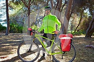 MTB Biker Bicycle touring in a pine forest