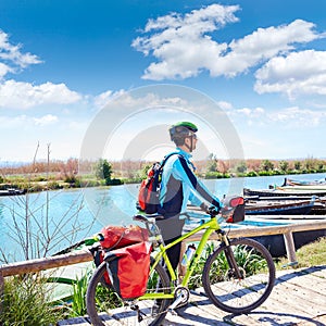 MTB Biker Bicycle touring on the river with pannier