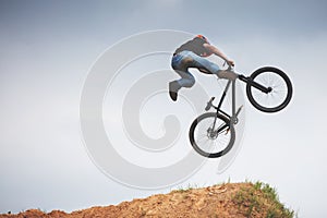 Mtb dirt rider doing trick on a jump
