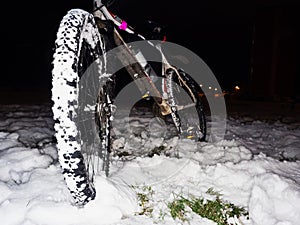 Mtb riding in snow.  Extreme fun. Front wheel with large grips on tyre