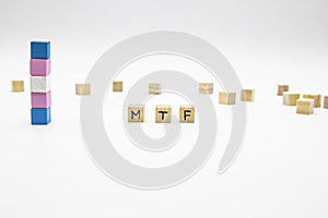 MTF lettering made of wooden cubes and transgender flag on white background. Conceptual illustration lesbian, gay, bisexual, and photo