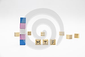 MTF lettering made of wooden cubes and transgender flag on white background. Conceptual illustration lesbian, gay, bisexual, and
