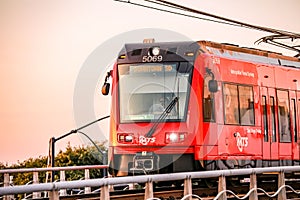 MTS trolley on bridge at sunset