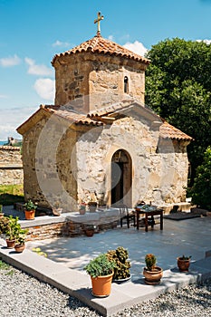 Mtskheta Georgia. Ancient Tiny Stone Church Of St. Nina With Green Churchyard