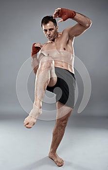 Muay thai fighter on gray background