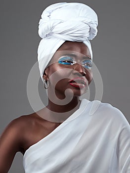 So much style in one garment. Studio shot of an attractive young woman posing in traditional African attire against a