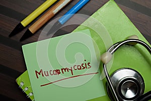 Mucormycosis write on sticky notes isolated on Wooden Table