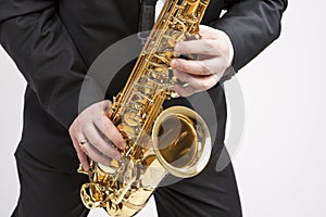 Mucs Concept. Closeup of Hands of Saxophone Player Playing on Sa