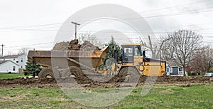 Mud-covered Commercial Dump Truck Driving Deep in Muddy Path