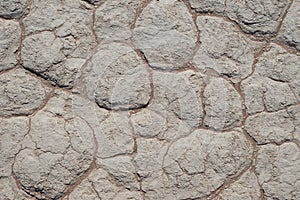 Mud cracks on clay soil with red sand. Sossusvlei, Namib Naukluft National Park. Natural background and texture.