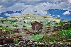 Mud house in the green volcanic landscape of the crater Maragua in the Cordillera close to Sucre, Bolivia