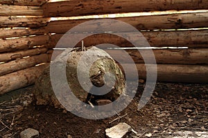 Mud oven inside log hut house in open-air museum