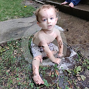 Mud puddle and toddler little boy