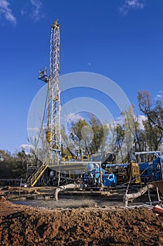 Mud pumps in front of oil drilling rig