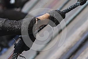 Mud race runners,defeating obstacles by using rope