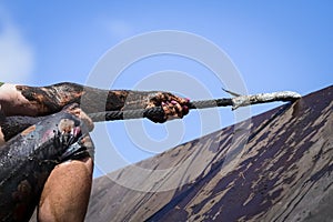 Mud race runners,defeating obstacles by using rope