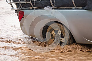 Mud splash by a car as it goes through flood water