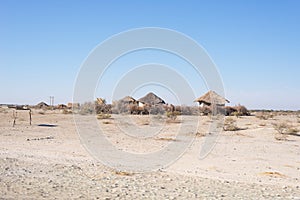 Mud straw and wooden hut with thatched roof in the bush. Local village in the rural Caprivi Strip, the most populated region in